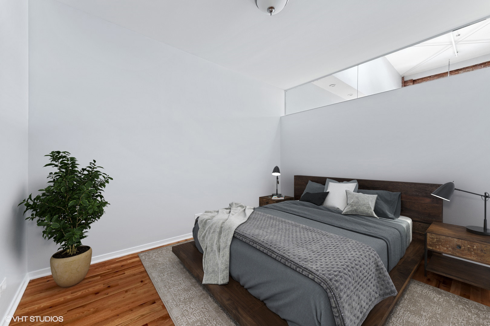 203 South Sangamon Street, Unit 304 Chicago, IL 60607 - Photo 12 of 15 a bedroom with a bed lamp and a potted plant