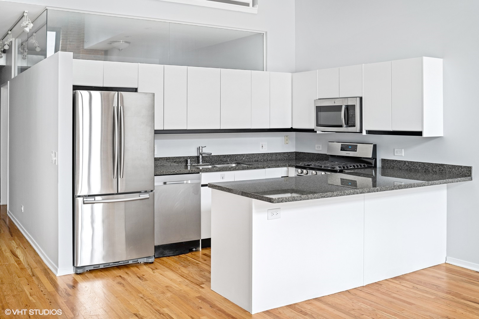 203 South Sangamon Street, Unit 304 Chicago, IL 60607 - Photo 3 of 15 a kitchen with a sink a refrigerator and cabinets