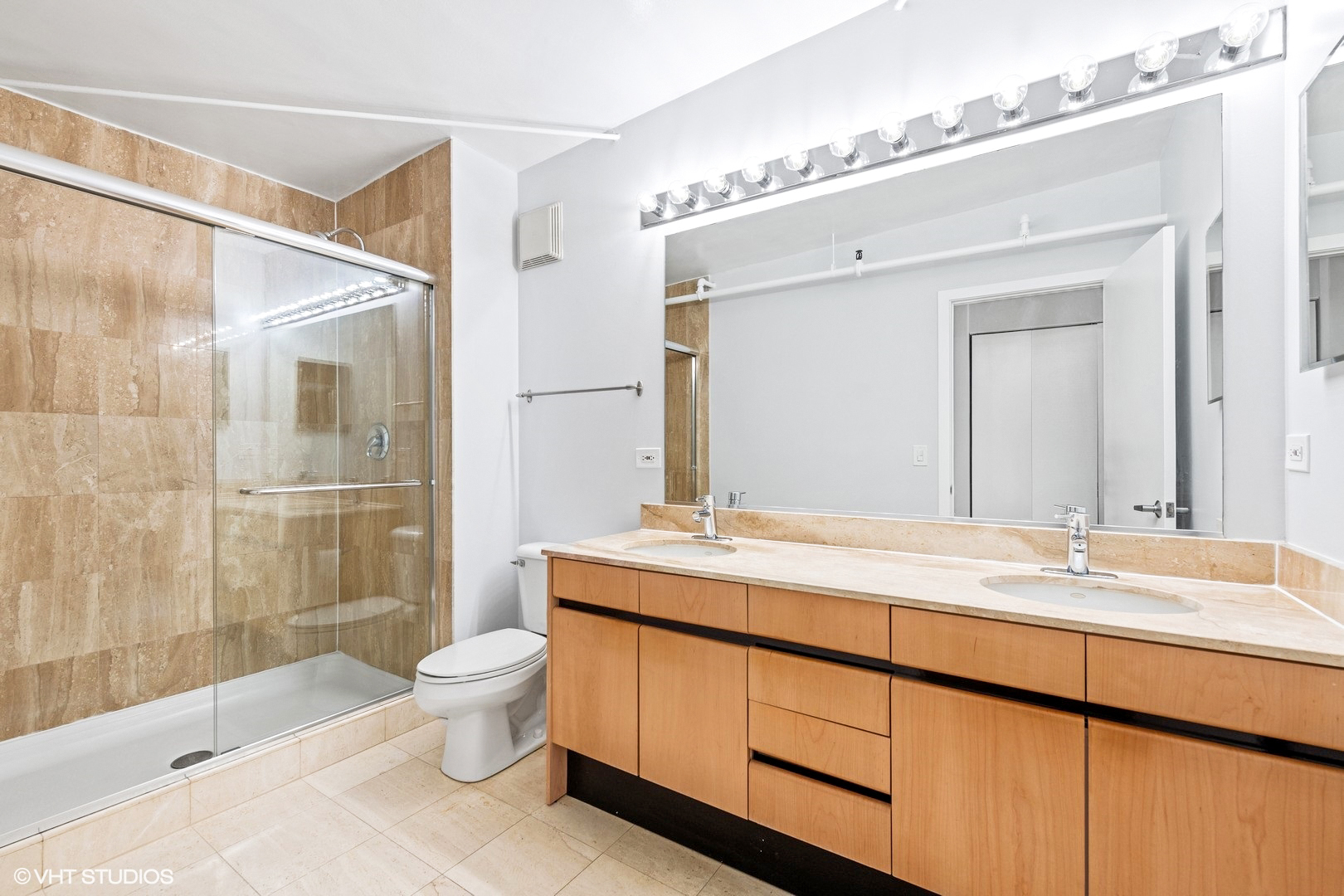 203 South Sangamon Street, Unit 304 Chicago, IL 60607 - Photo 10 of 15 a bathroom with a sink mirror toilet and shower