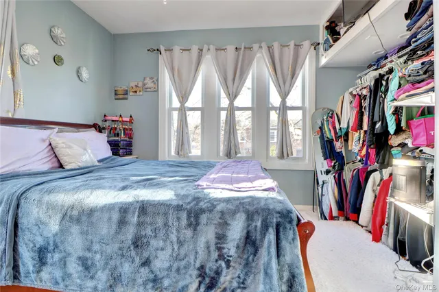 a bed sitting in a bedroom next to a window