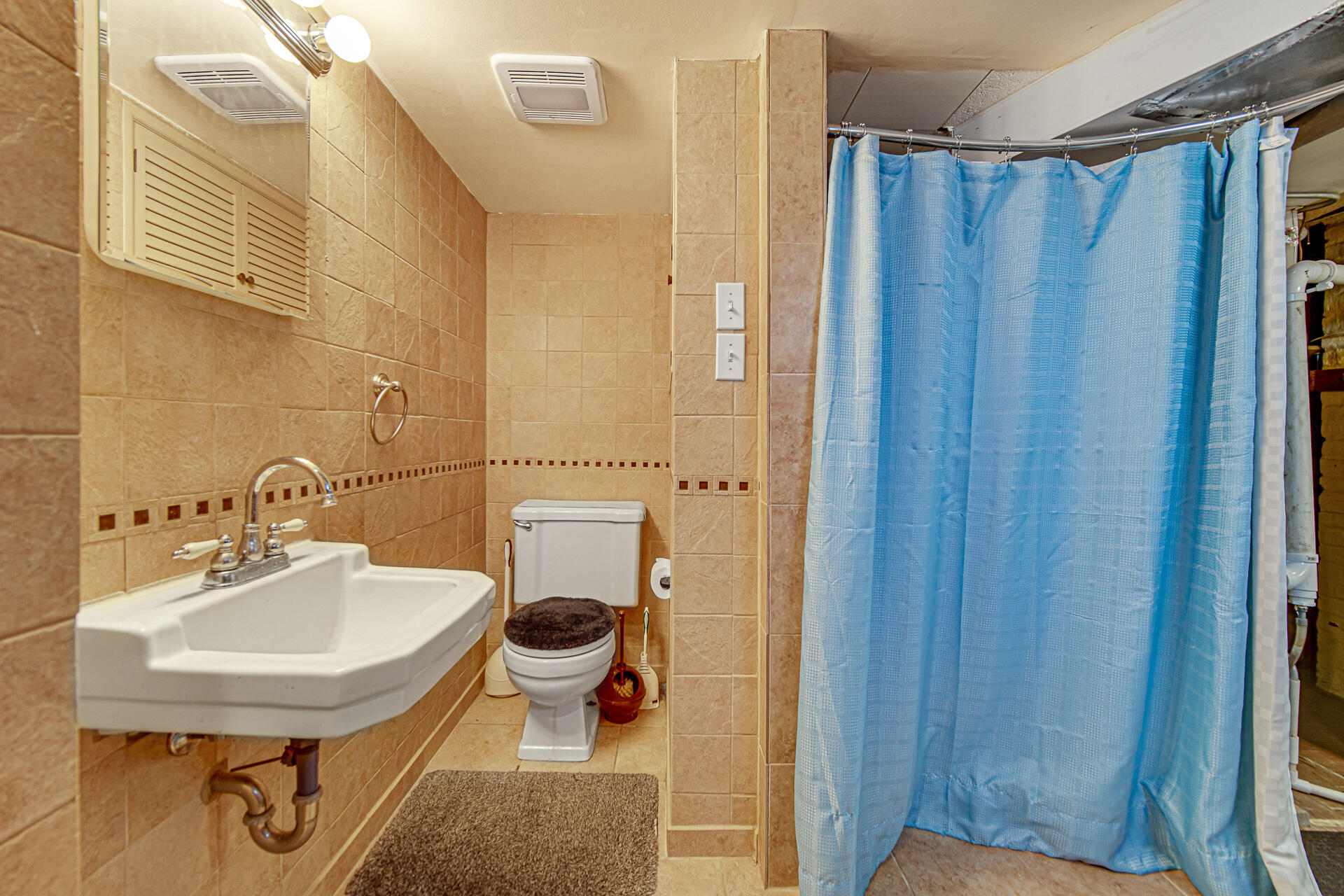928 176th Street Hammond, IN 46324 - Photo 18 of 25 a bathroom with a sink a toilet and shower