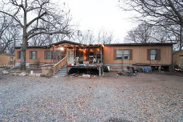 a view of a house with a yard and a tree