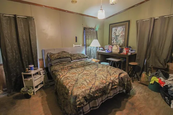 a bedroom with a bed window and a mirror