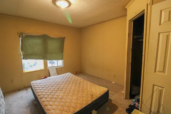 a bedroom with a bed and a window