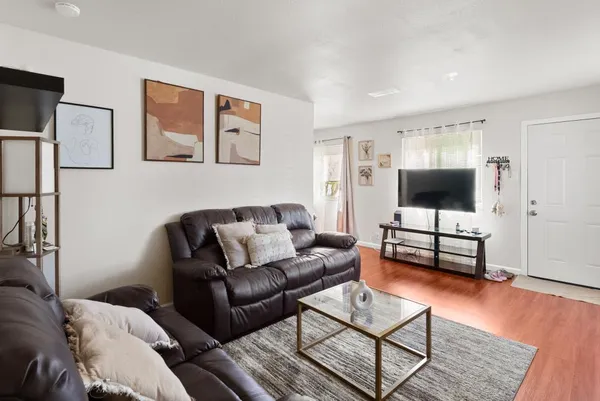 a kitchen with granite countertop a refrigerator and wooden floor