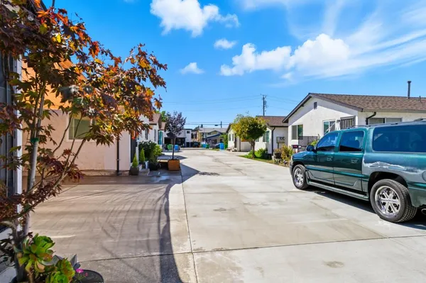a view of a street with a cars parked in front of it