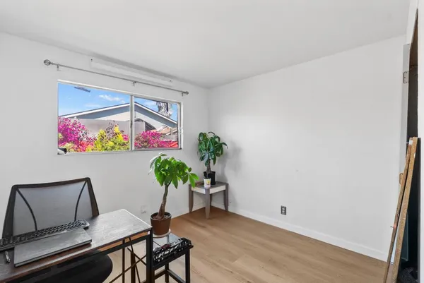 an aerial view of residential houses with outdoor space and parking