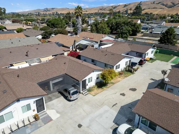 an aerial view of a houses with a swimming pool