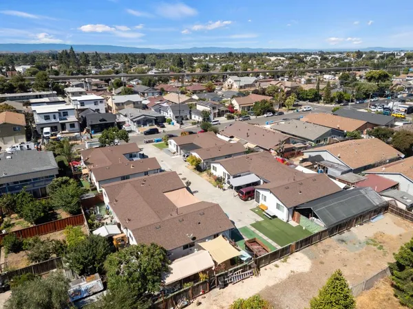 an aerial view of a houses with a city view