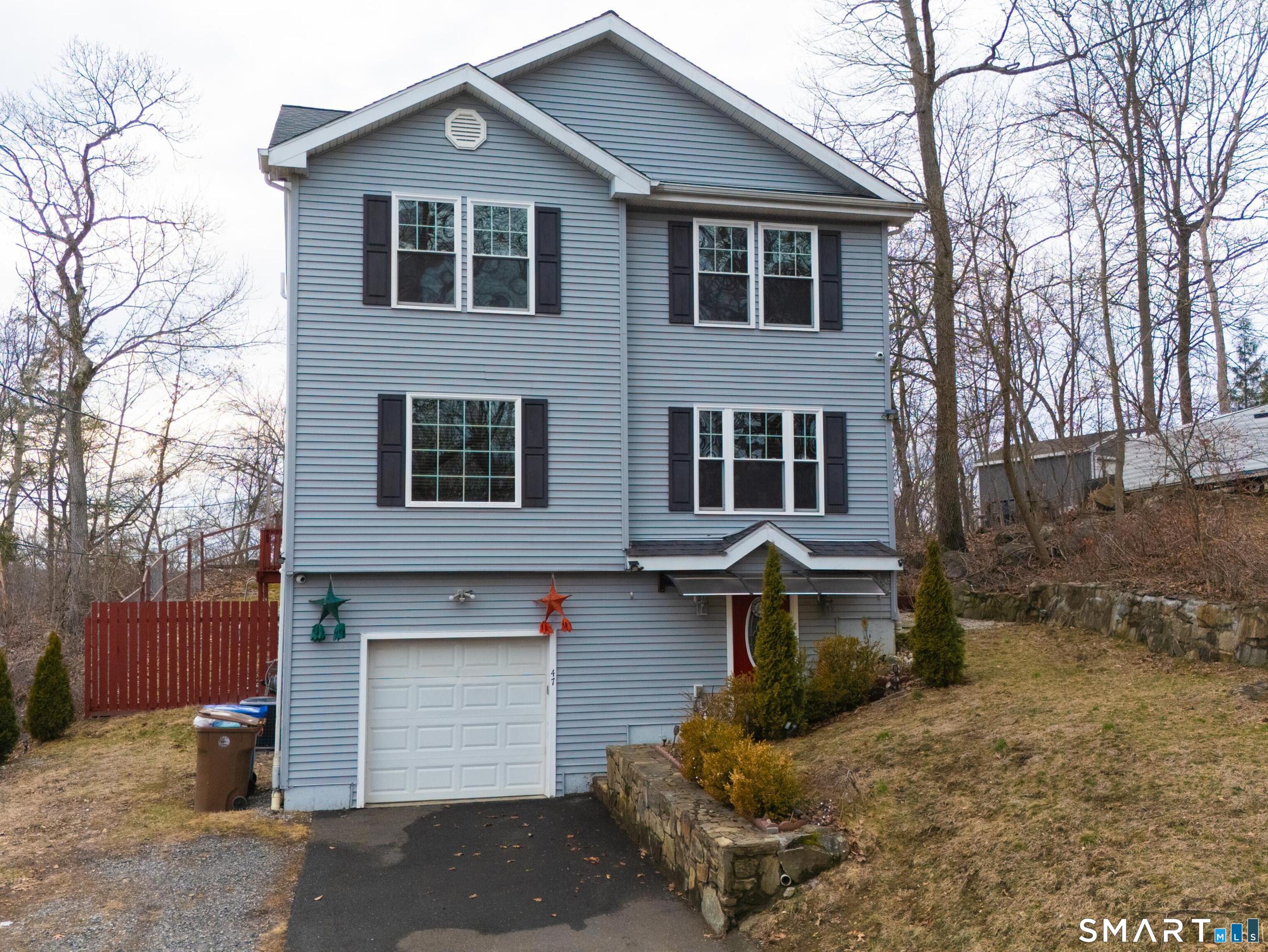 47 Oronoque Trail Shelton, CT 06484 - Photo 1 of 44 a front view of a house with a yard and garage
