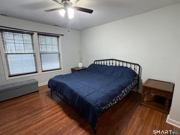 a bed sitting in a bedroom next to a window