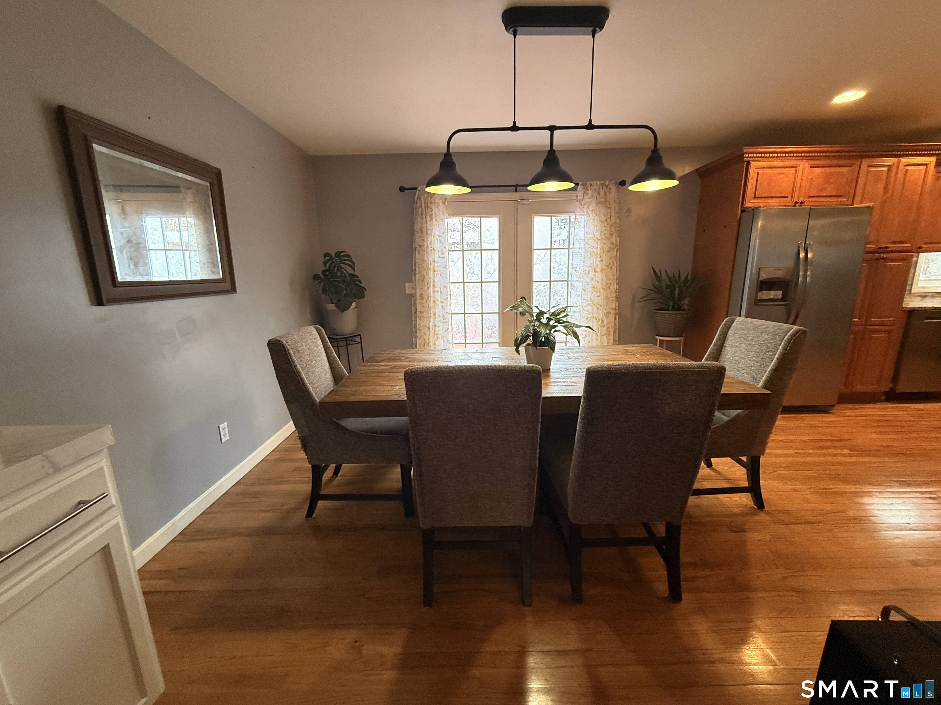 47 Oronoque Trail Shelton, CT 06484 - Photo 15 of 44 a dining room with furniture a chandelier and wooden floor
