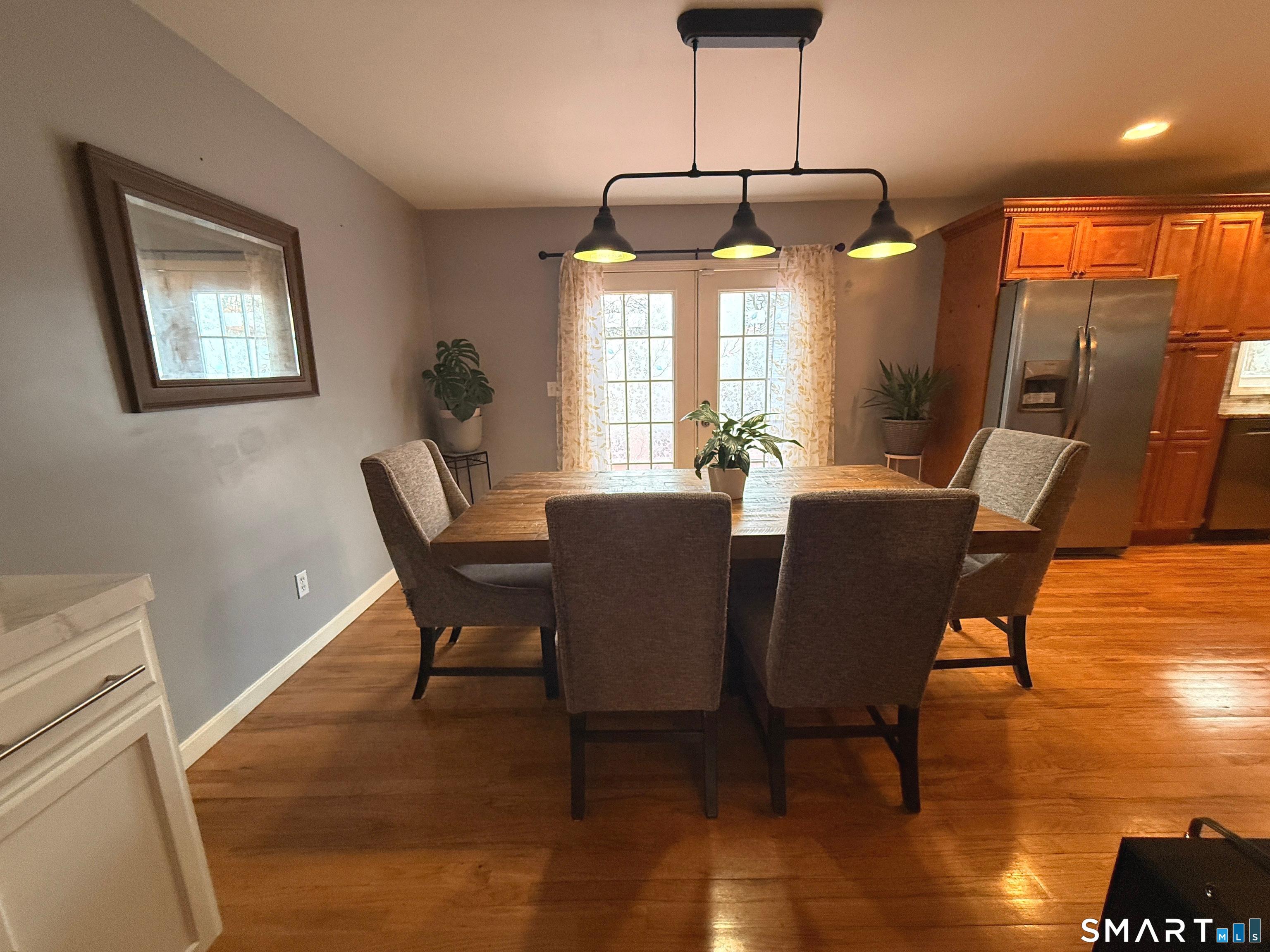 47 Oronoque Trail Shelton, CT 06484 - Photo 16 of 44 a dining room with furniture a chandelier and wooden floor