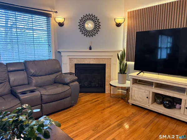 a living room with furniture a fireplace and a flat screen tv