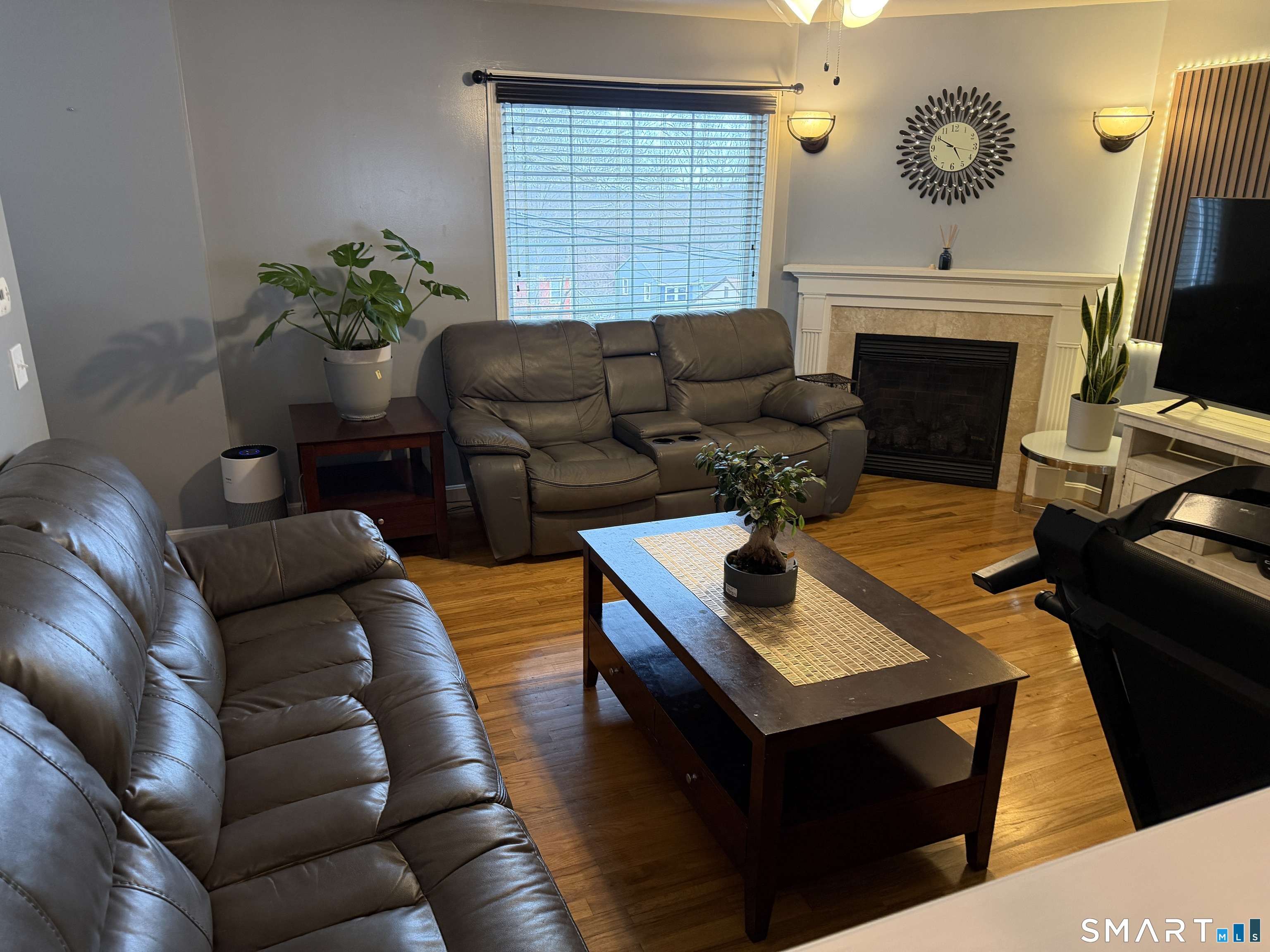 47 Oronoque Trail Shelton, CT 06484 - Photo 22 of 44 a living room with furniture a fireplace and a flat screen tv