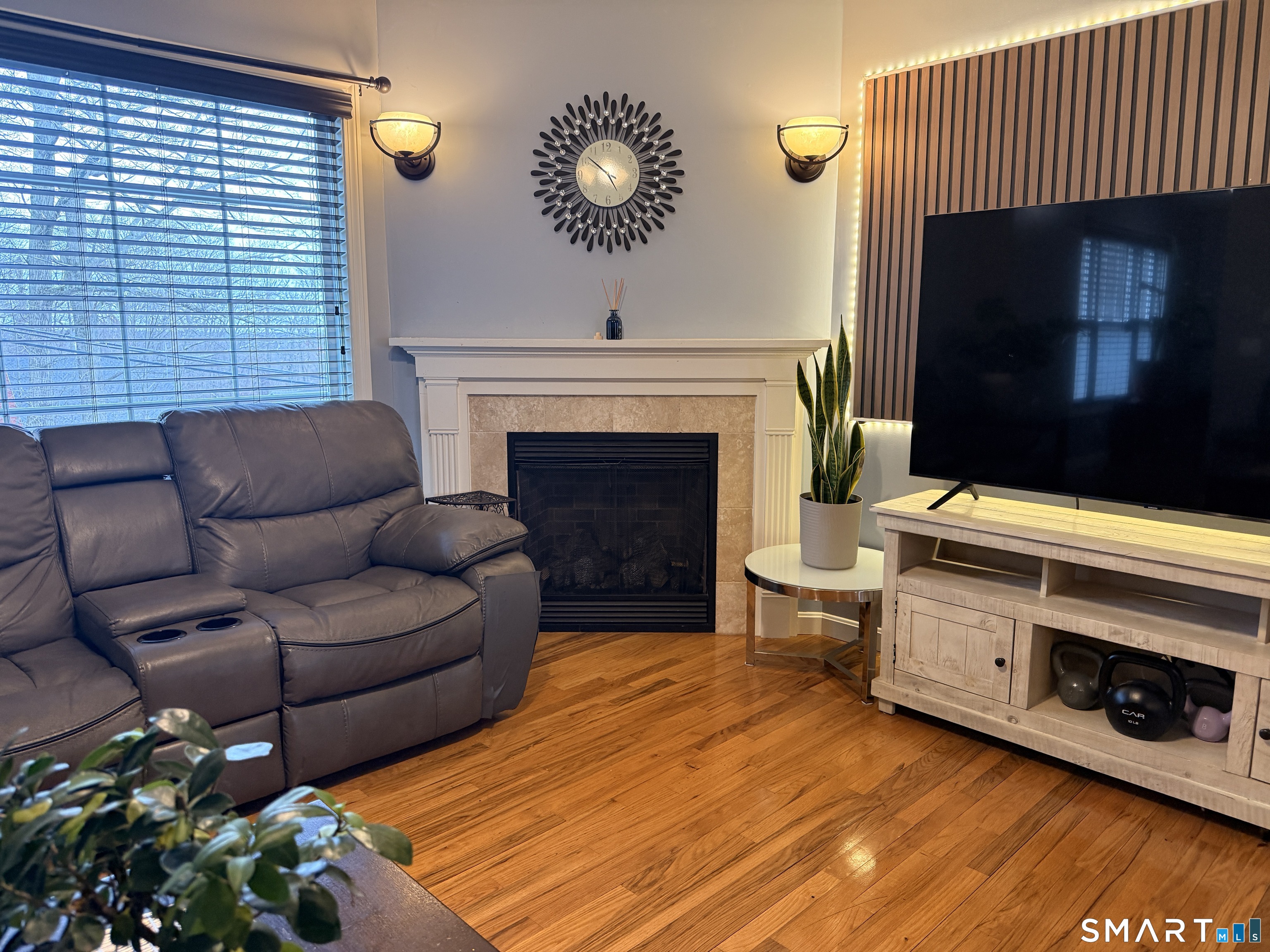 47 Oronoque Trail Shelton, CT 06484 - Photo 27 of 44 a living room with furniture a fireplace and a flat screen tv