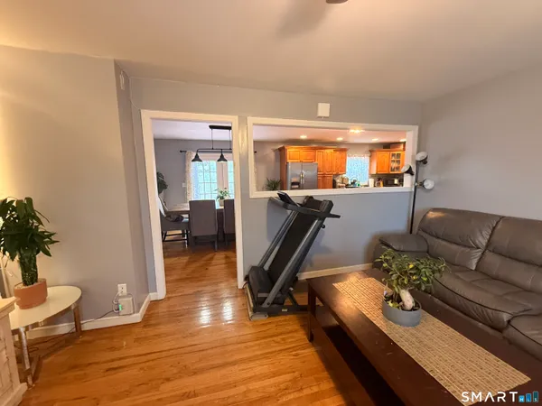 a living room with furniture and wooden floor