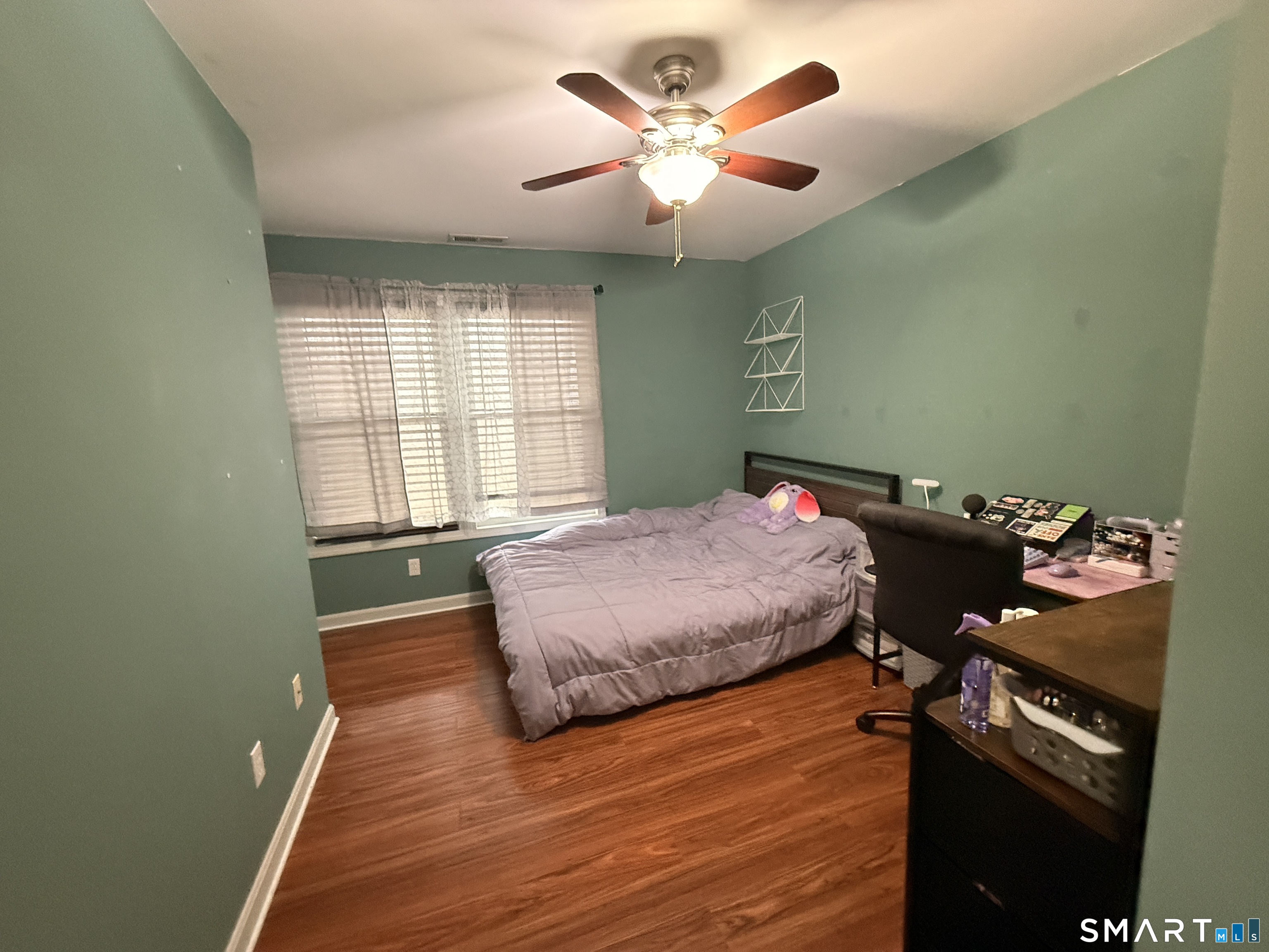 47 Oronoque Trail Shelton, CT 06484 - Photo 33 of 44 a bedroom with a bed and a chandelier