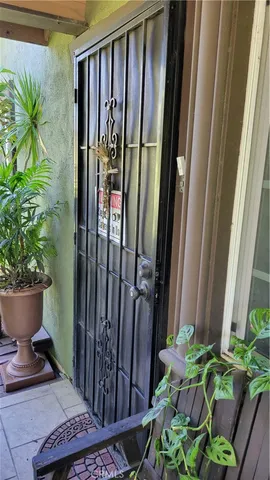 a flower garden with a chair and a potted plant