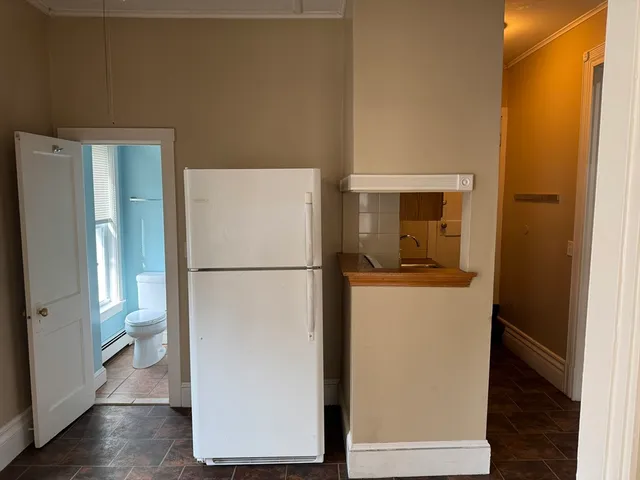 a utility room with wooden floor washer and dryer