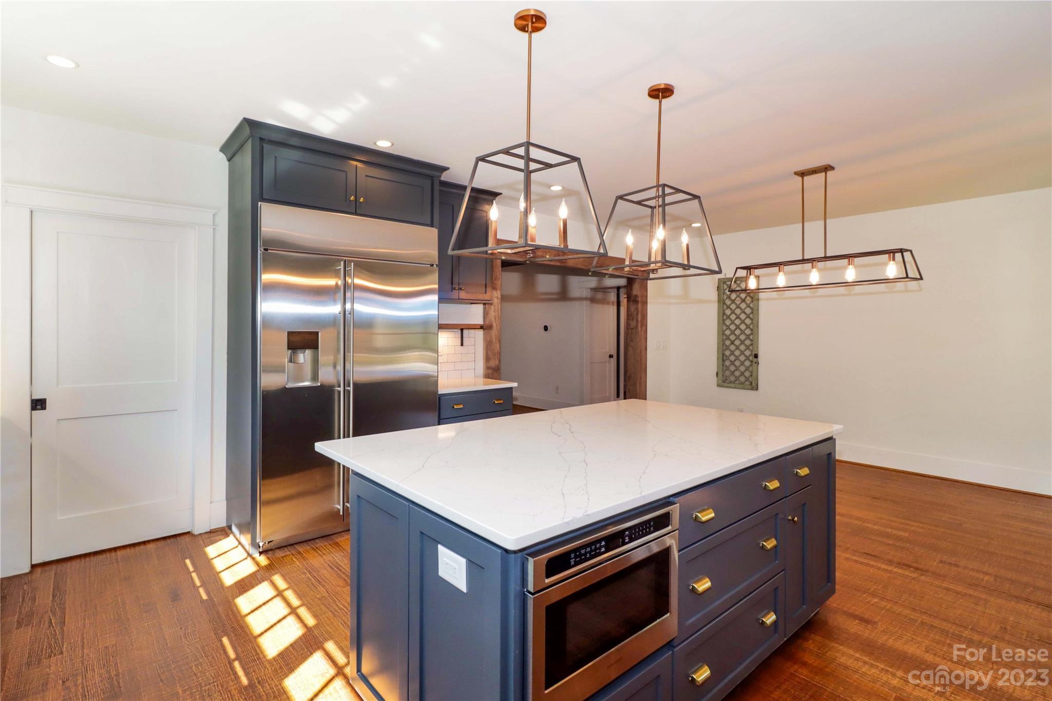 517 Lorimer Road Davidson, NC 28036 - Photo 14 of 48 a kitchen with stainless steel appliances granite countertop a refrigerator a sink and a wooden floors