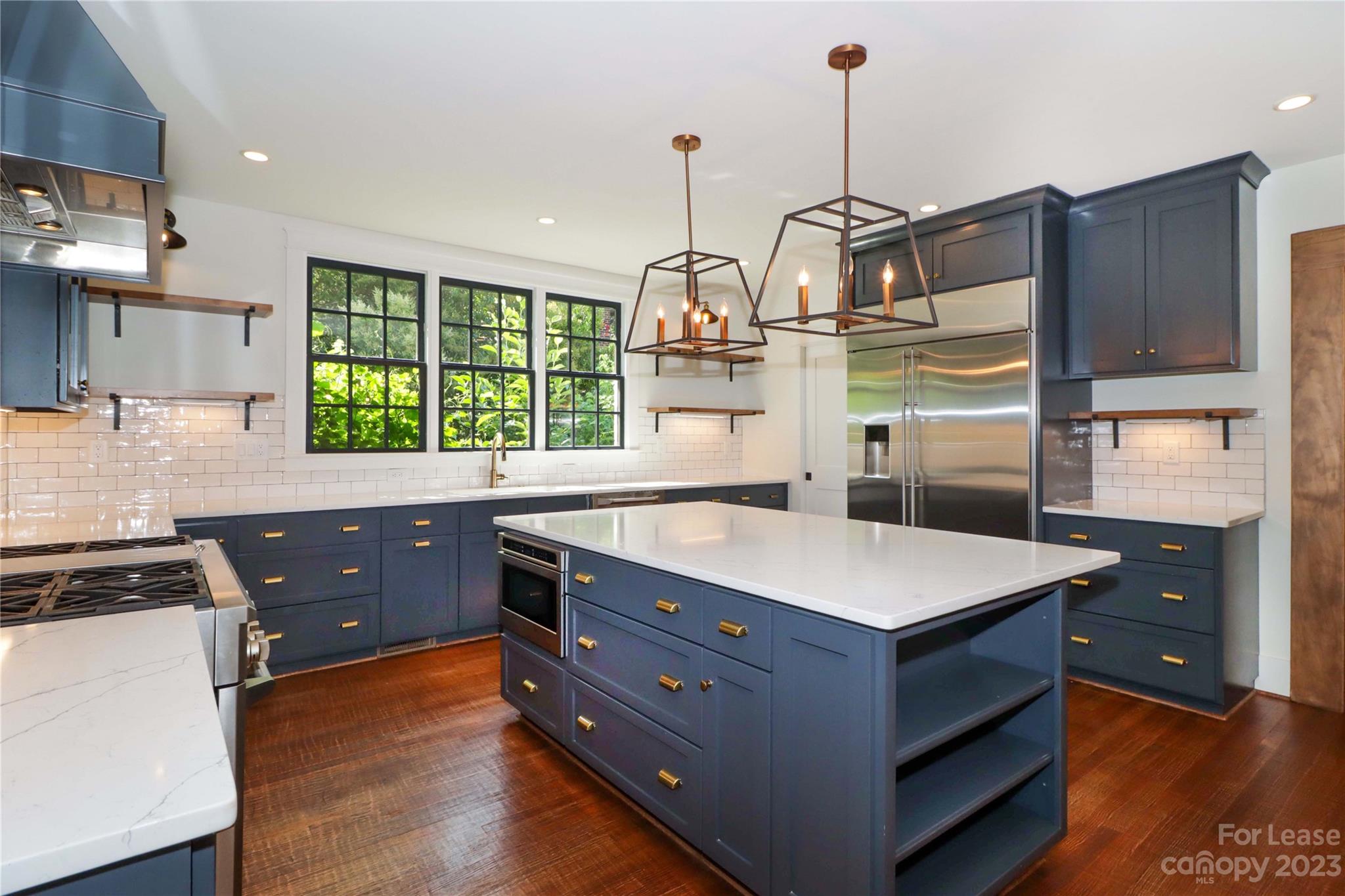 517 Lorimer Road Davidson, NC 28036 - Photo 15 of 48 a kitchen with a stove a window and wooden cabinets