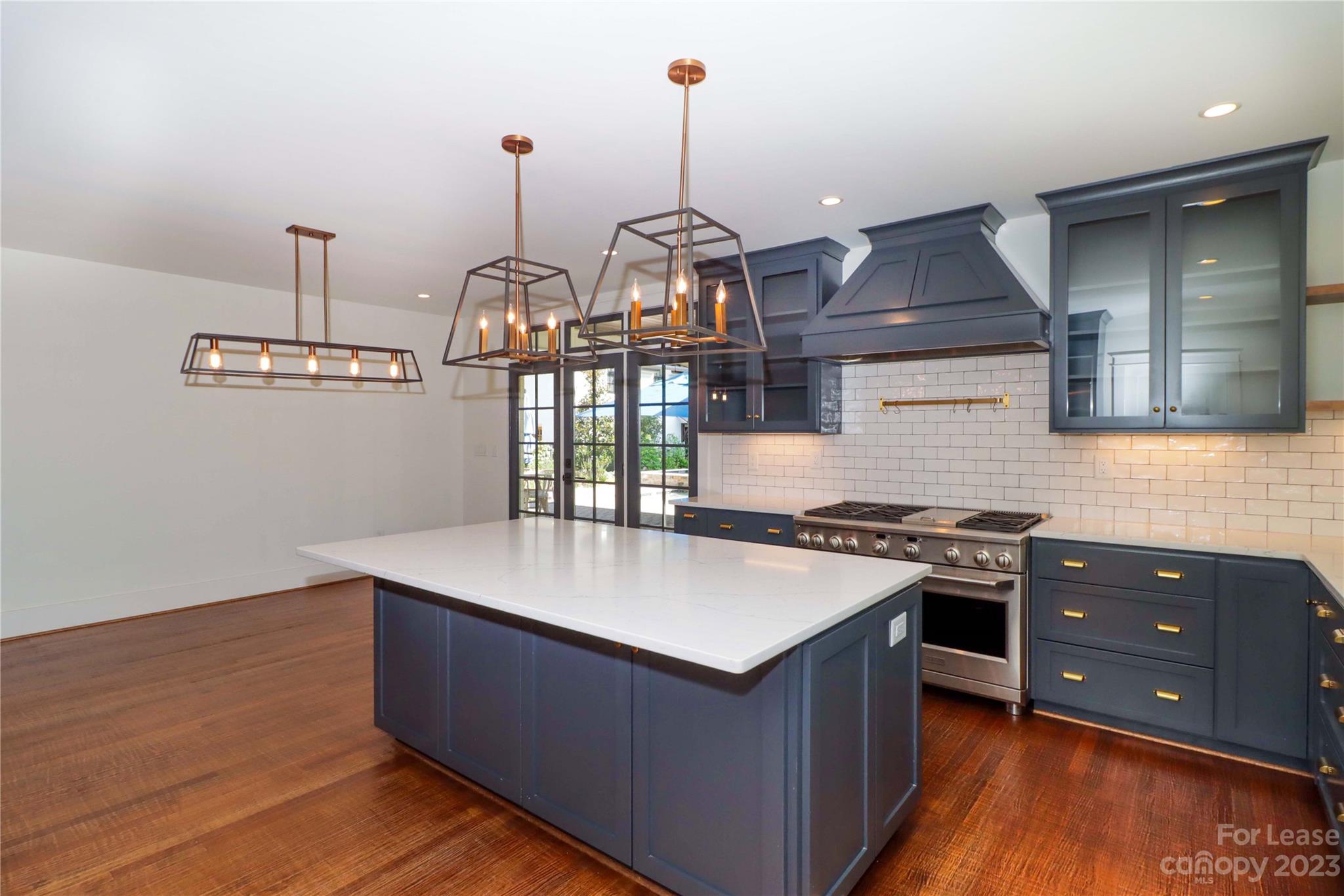 517 Lorimer Road Davidson, NC 28036 - Photo 17 of 48 a kitchen with sink cabinets and wooden floor
