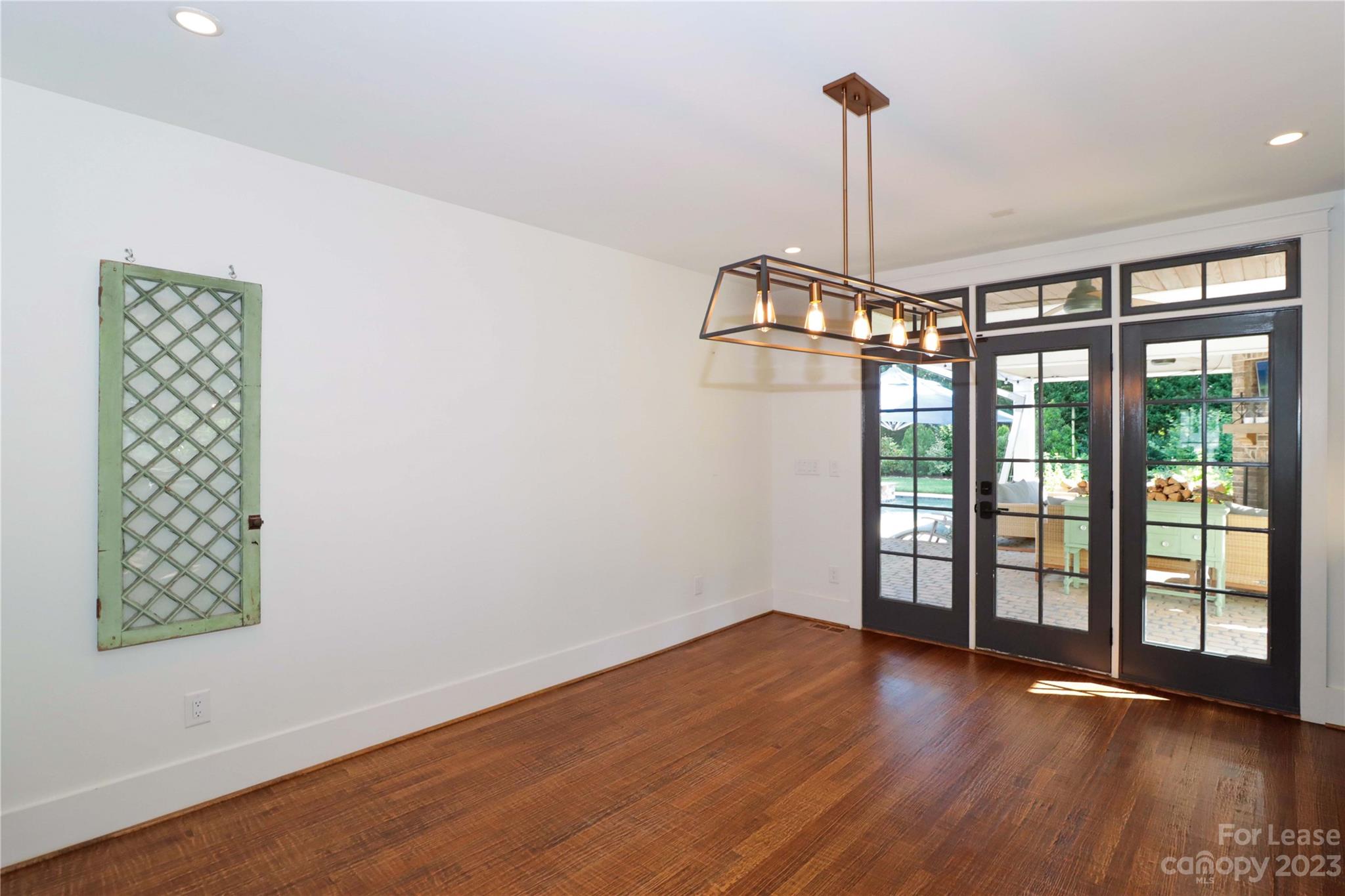 517 Lorimer Road Davidson, NC 28036 - Photo 19 of 48 a view of empty room with wooden floor and fan