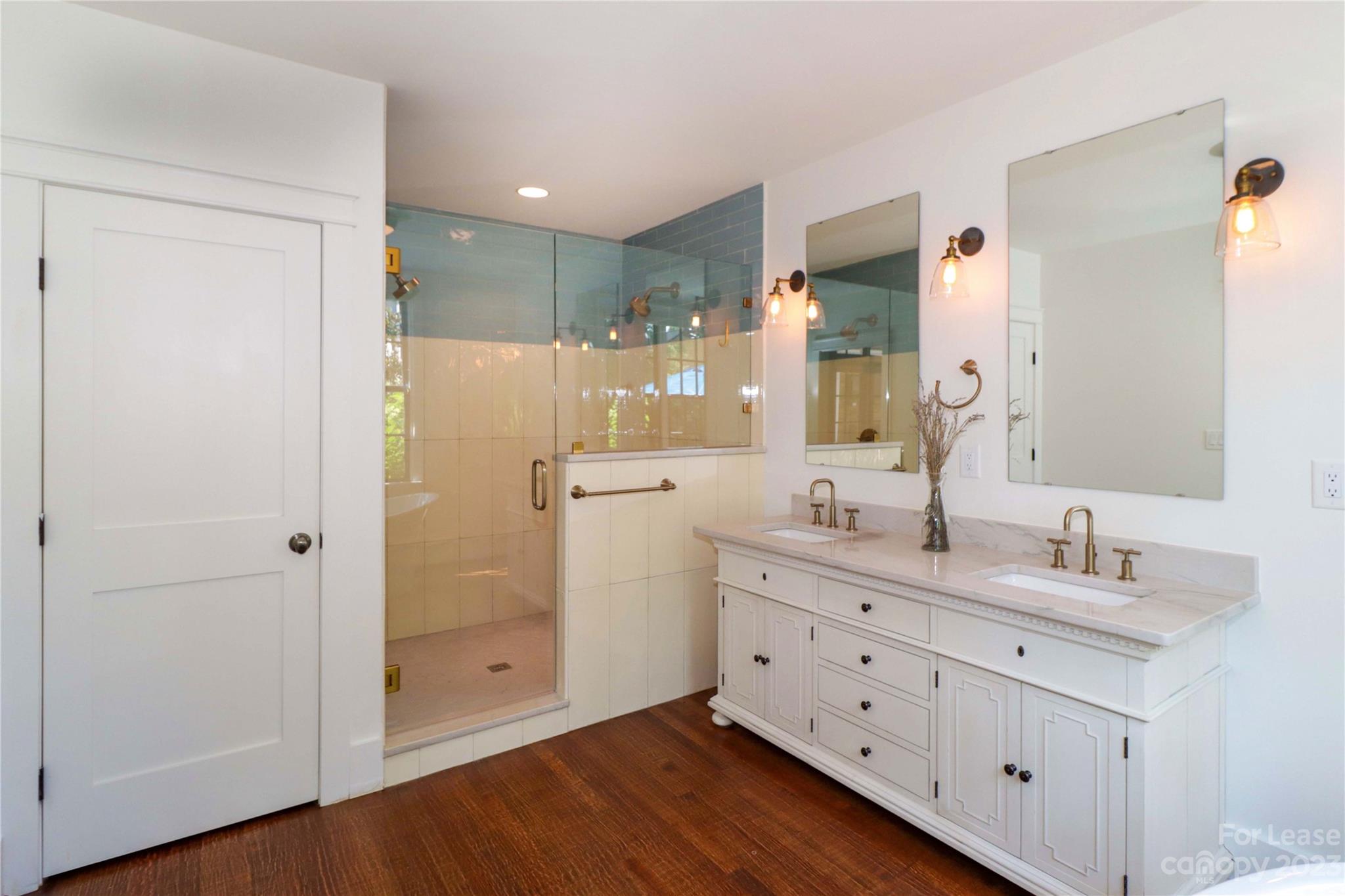 517 Lorimer Road Davidson, NC 28036 - Photo 22 of 48 a bathroom with a double vanity sink and mirror