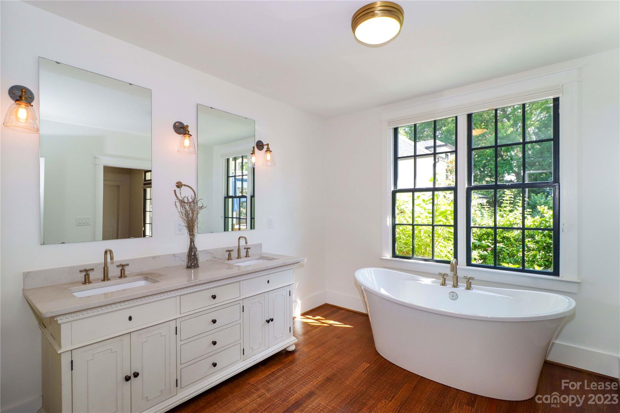 517 Lorimer Road Davidson, NC 28036 - Photo 23 of 48 a spacious bathroom with a tub double sink mirror and window