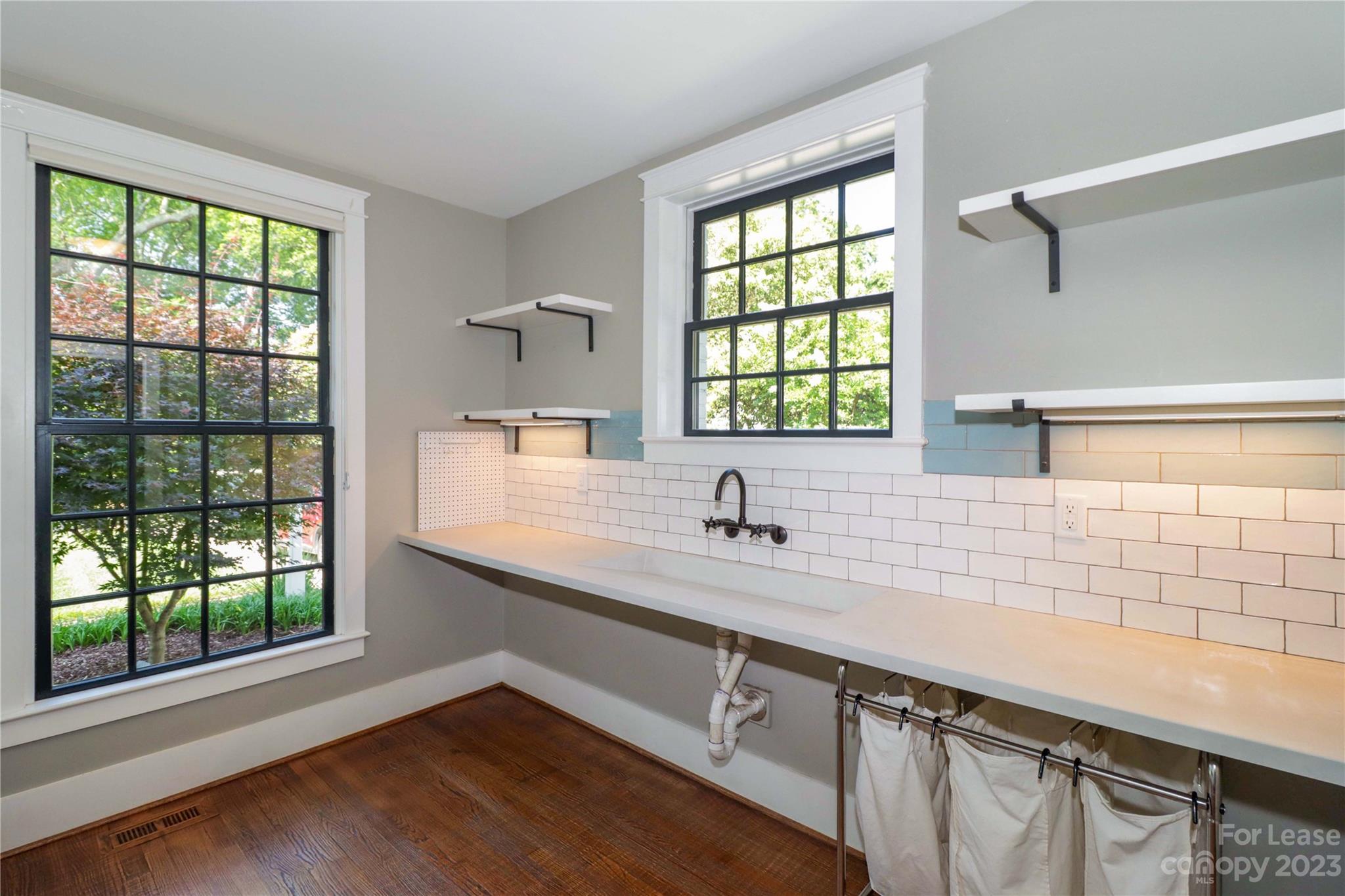 517 Lorimer Road Davidson, NC 28036 - Photo 26 of 48 a kitchen with a sink window and cabinets