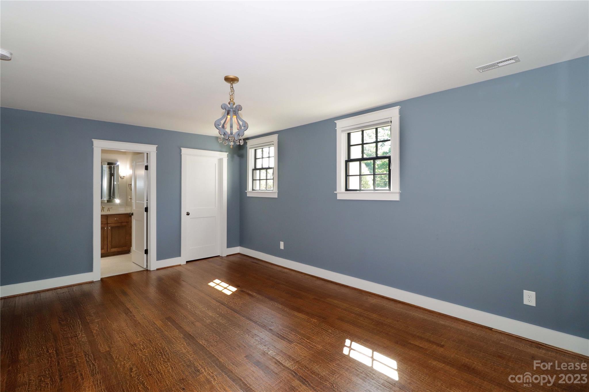 517 Lorimer Road Davidson, NC 28036 - Photo 28 of 48 a view of an empty room with wooden floor and a window