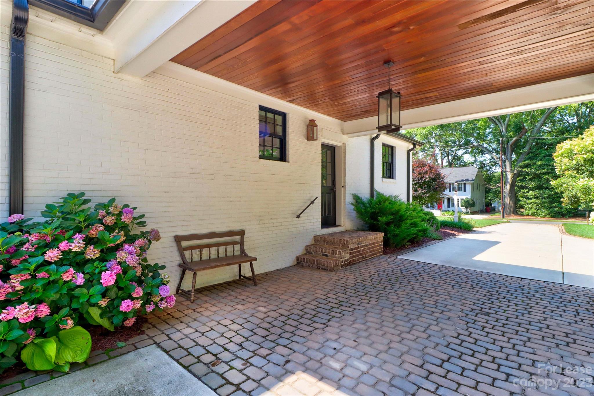 517 Lorimer Road Davidson, NC 28036 - Photo 32 of 48 a wooden bench sitting in front of a house