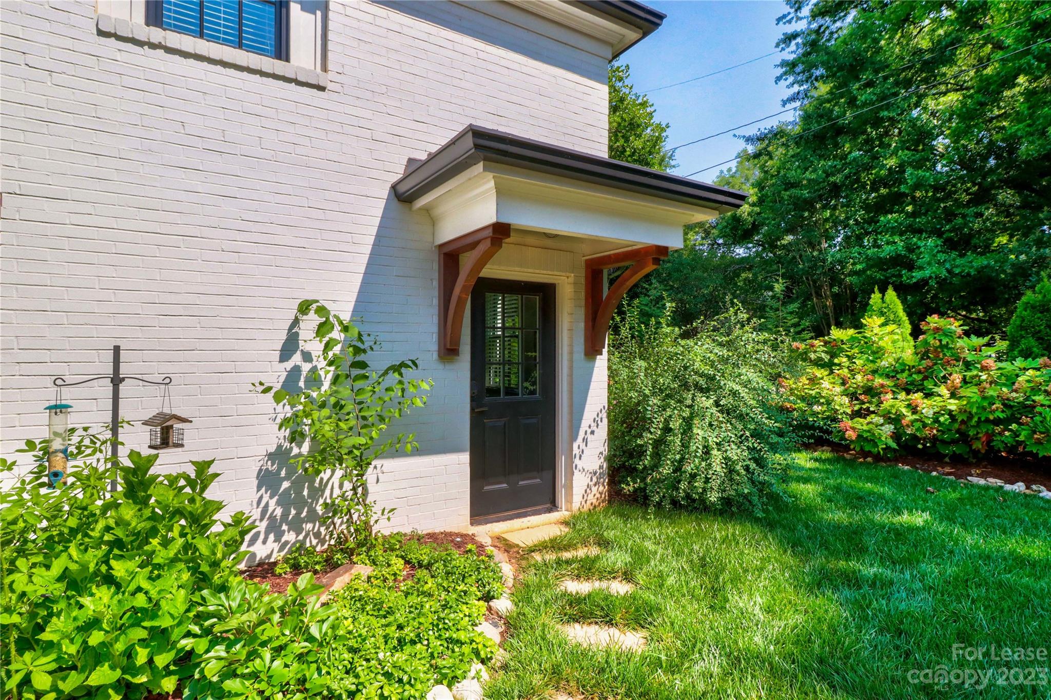517 Lorimer Road Davidson, NC 28036 - Photo 35 of 48 a front view of a house with garden