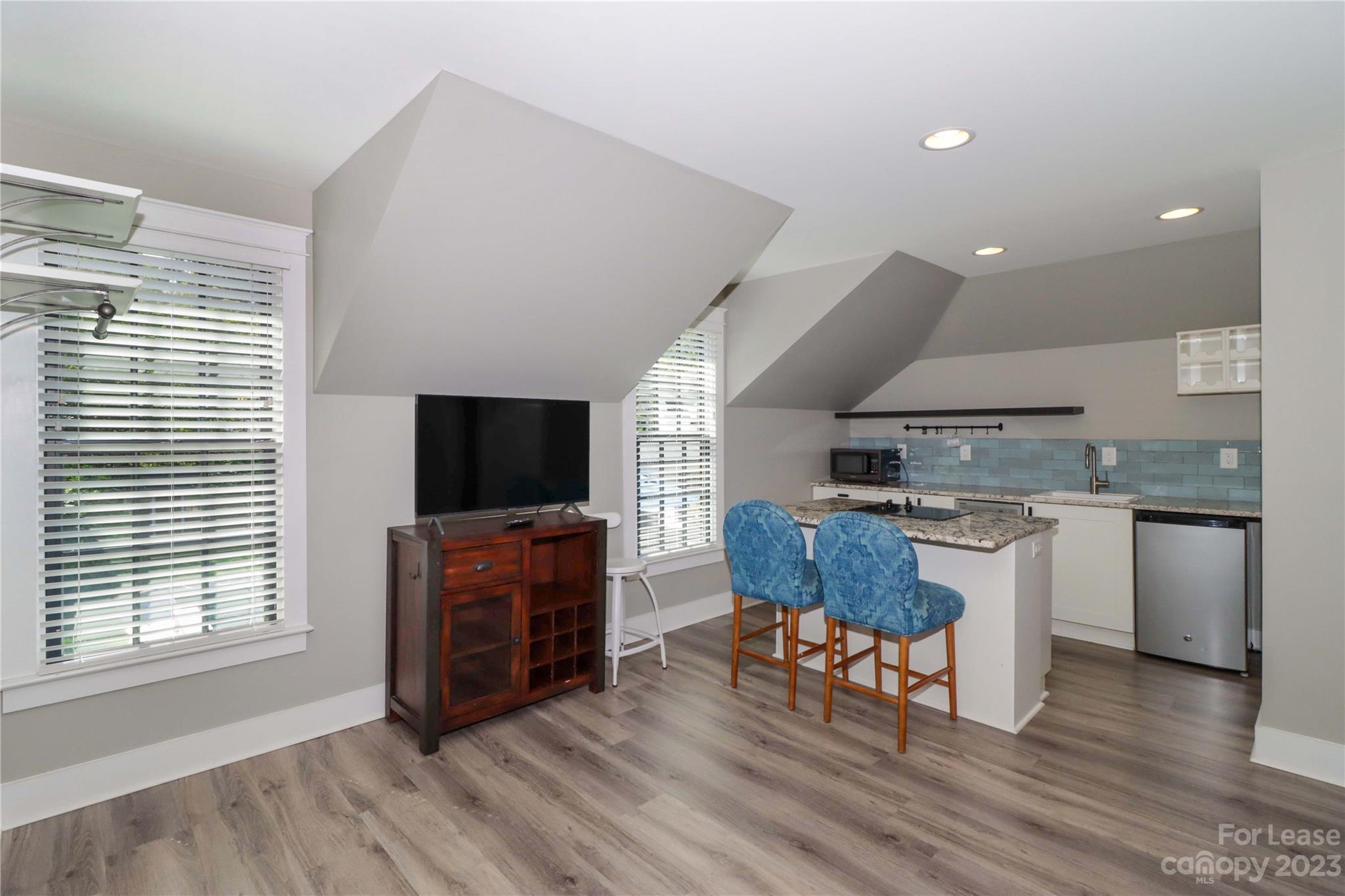 517 Lorimer Road Davidson, NC 28036 - Photo 37 of 48 a living room with furniture and a flat screen tv