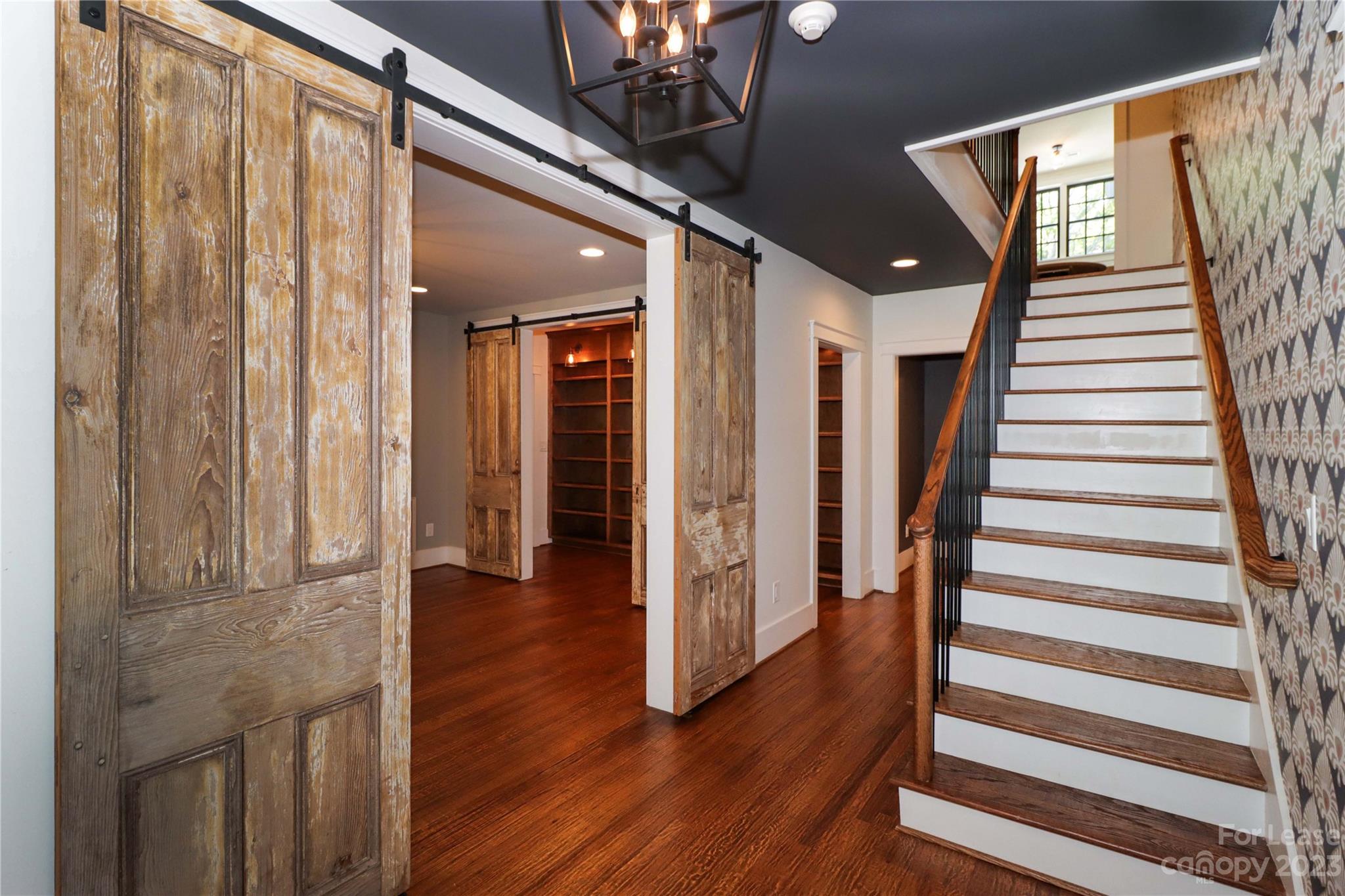 517 Lorimer Road Davidson, NC 28036 - Photo 9 of 48 a view of a hallway with wooden floor and staircase
