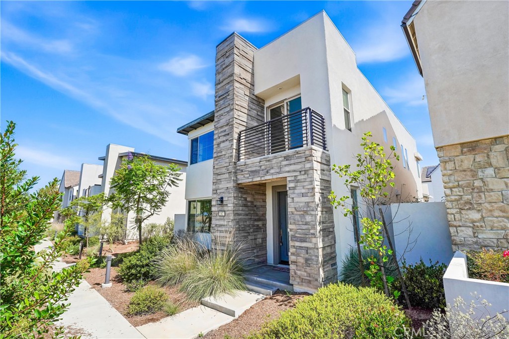 182 Scale Irvine, CA 92618 - Photo 6 of 61 Stone tower, modern lines, and a door that makes a statement before you ever step inside.