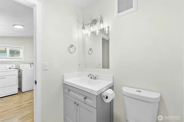 a bathroom with a sink a toilet and a mirror