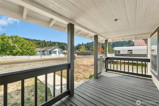 a view of a balcony with wooden floor