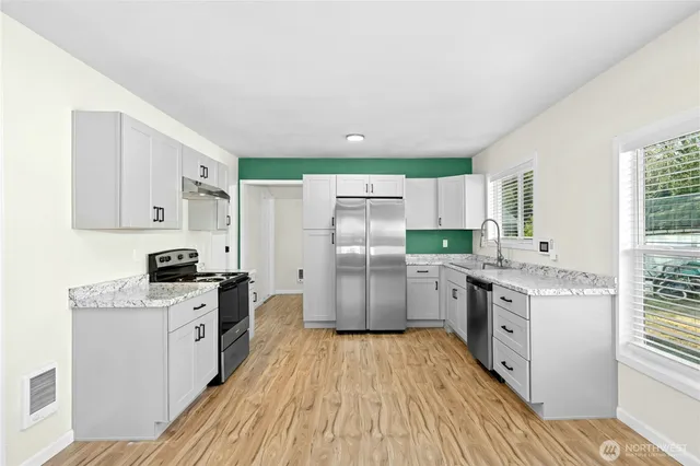 a kitchen with a sink dishwasher stove and refrigerator