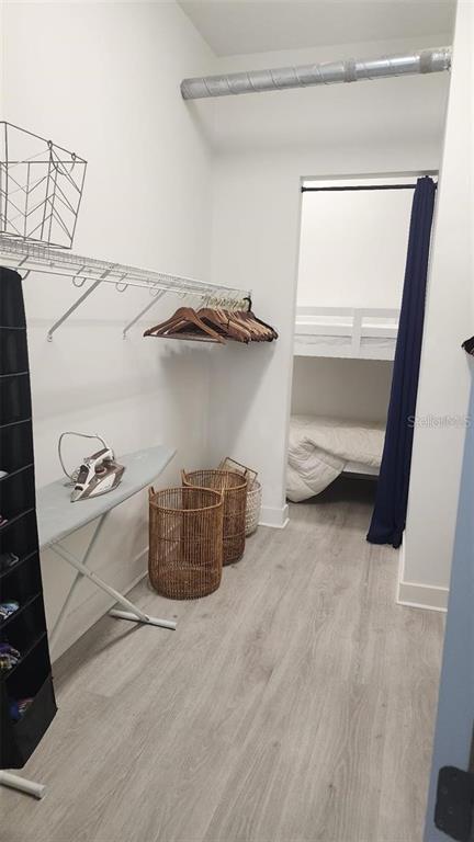 150 East Robinson Street, Unit 4A13 Orlando, FL 32801 - Photo 13 of 30 a view of walk in closet with clothes and shoes