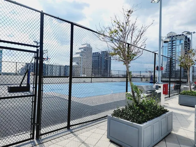 a view of roof deck with couches and potted plants