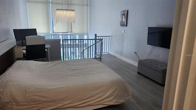 a bedroom with a bed and a couch