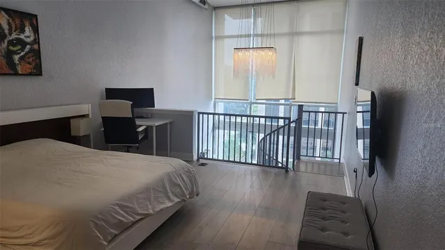 a bedroom with a bed and a table in it