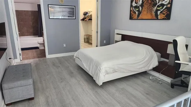 a bed sitting in a bedroom next to a window