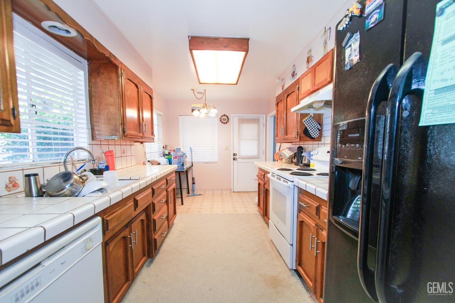 Undisclosed Address Bakersfield, CA 93309 - Photo 11 of 19 a kitchen with stainless steel appliances granite countertop a sink and dishwasher
