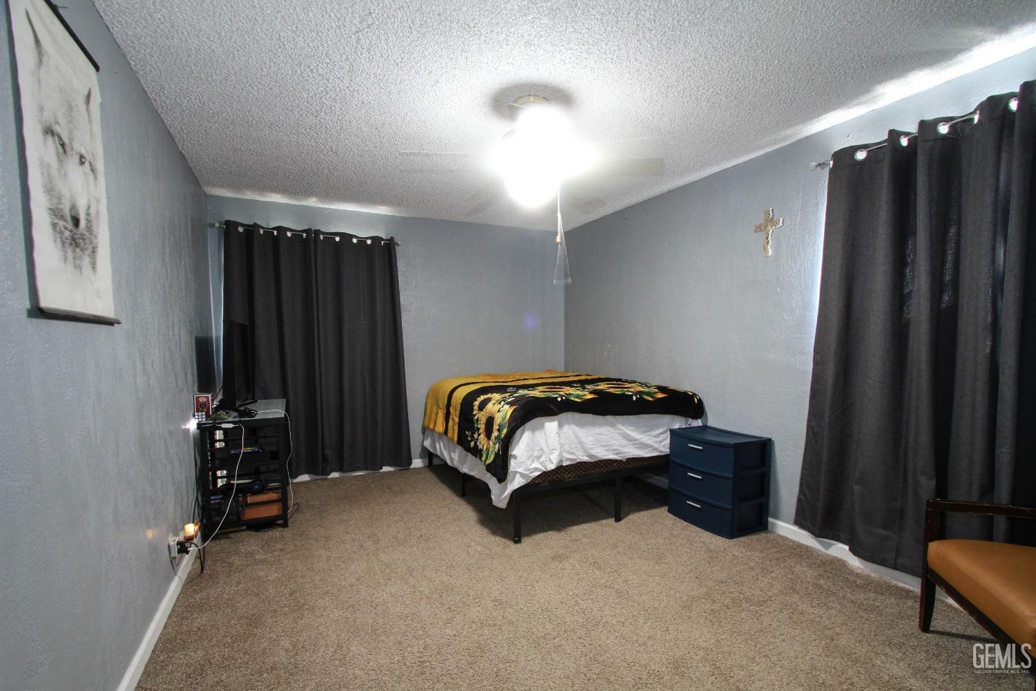 Undisclosed Address Bakersfield, CA 93309 - Photo 13 of 19 a bedroom with a bed and a furniture