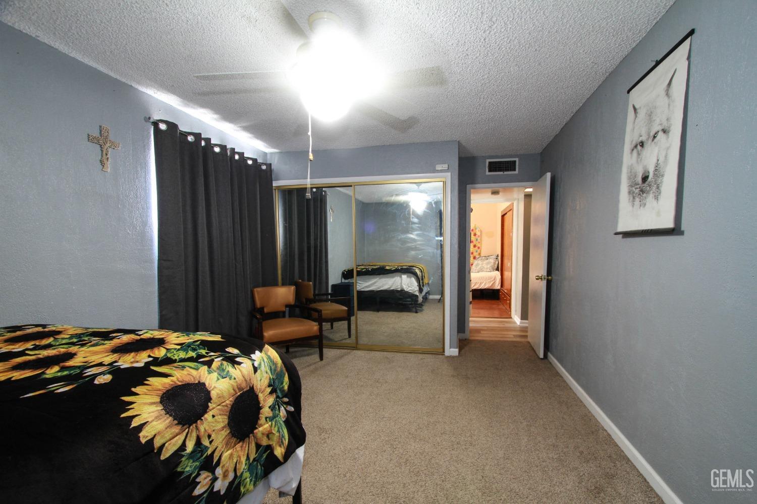 Undisclosed Address Bakersfield, CA 93309 - Photo 14 of 19 a bedroom with a bed and a large mirror