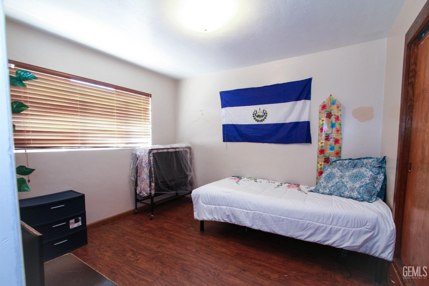 Undisclosed Address Bakersfield, CA 93309 - Photo 15 of 19 a bedroom with a bed and wooden floor