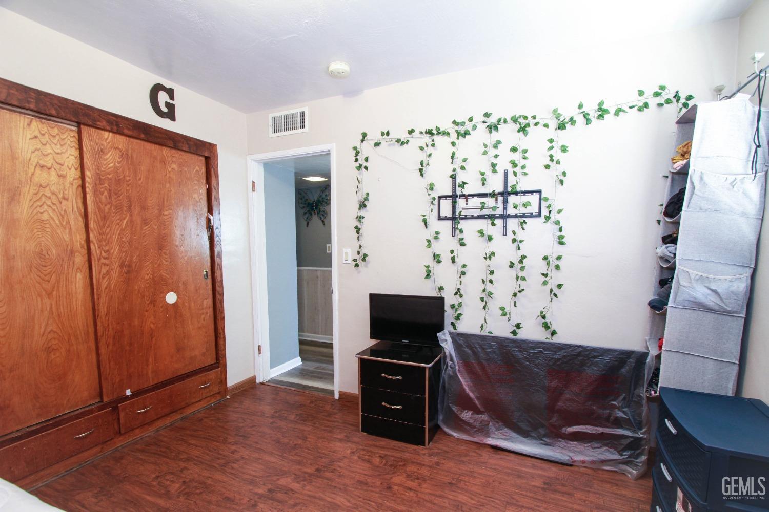 Undisclosed Address Bakersfield, CA 93309 - Photo 16 of 19 a living room with furniture and a flat screen tv